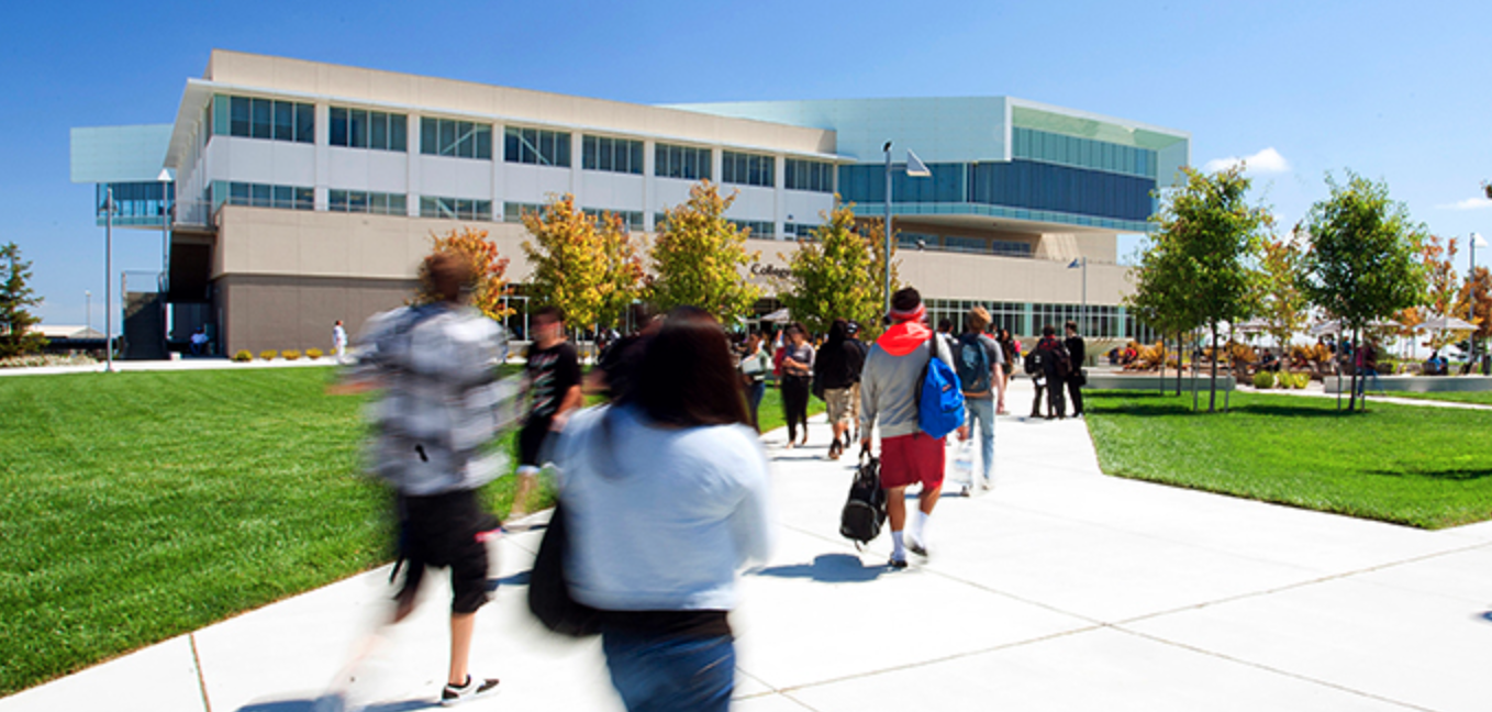 Students walking in to College of San Mateo campus building.